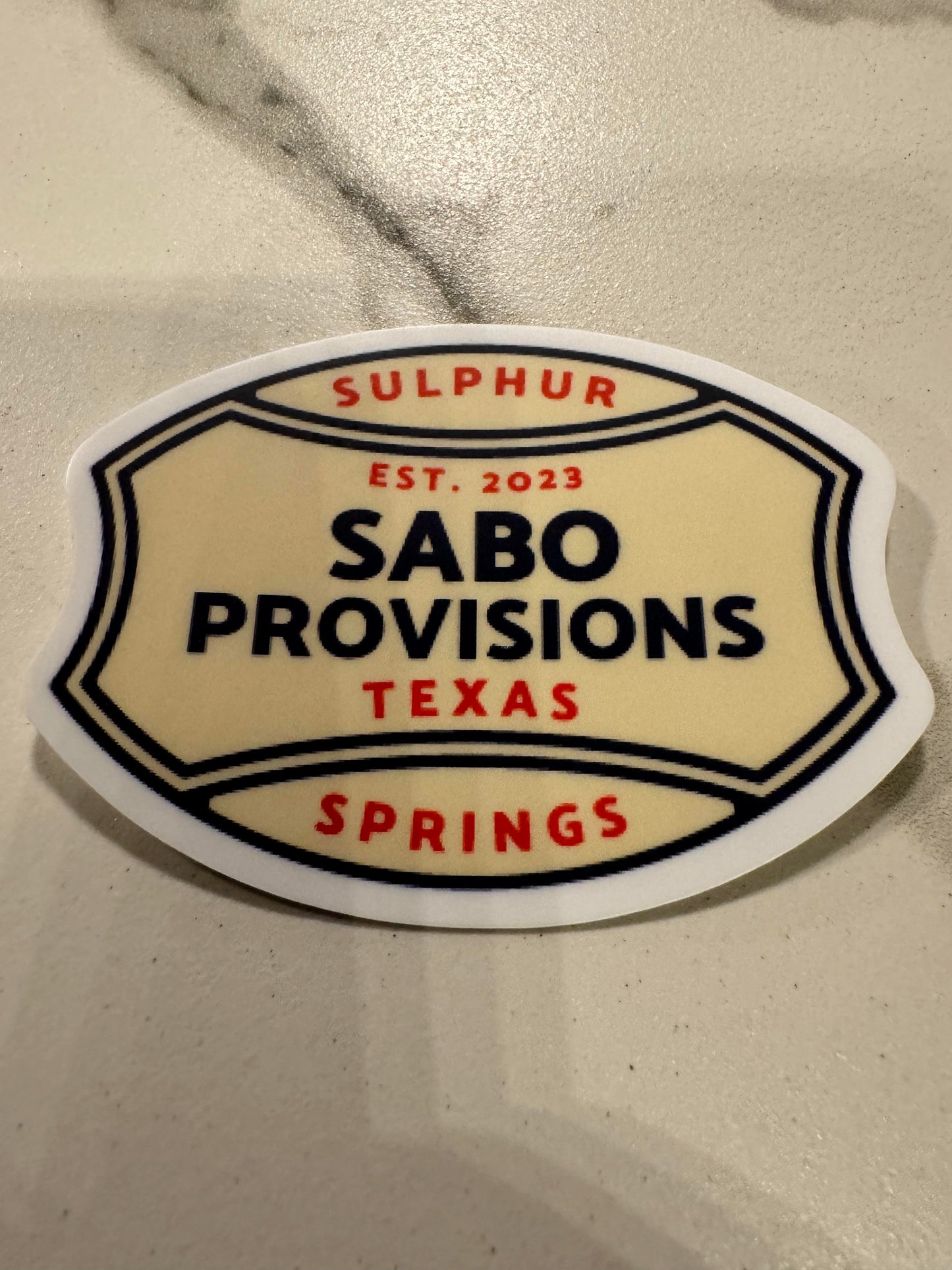 Sabo Provisions Est 2023 Blue & Tan Football Shaped Sticker